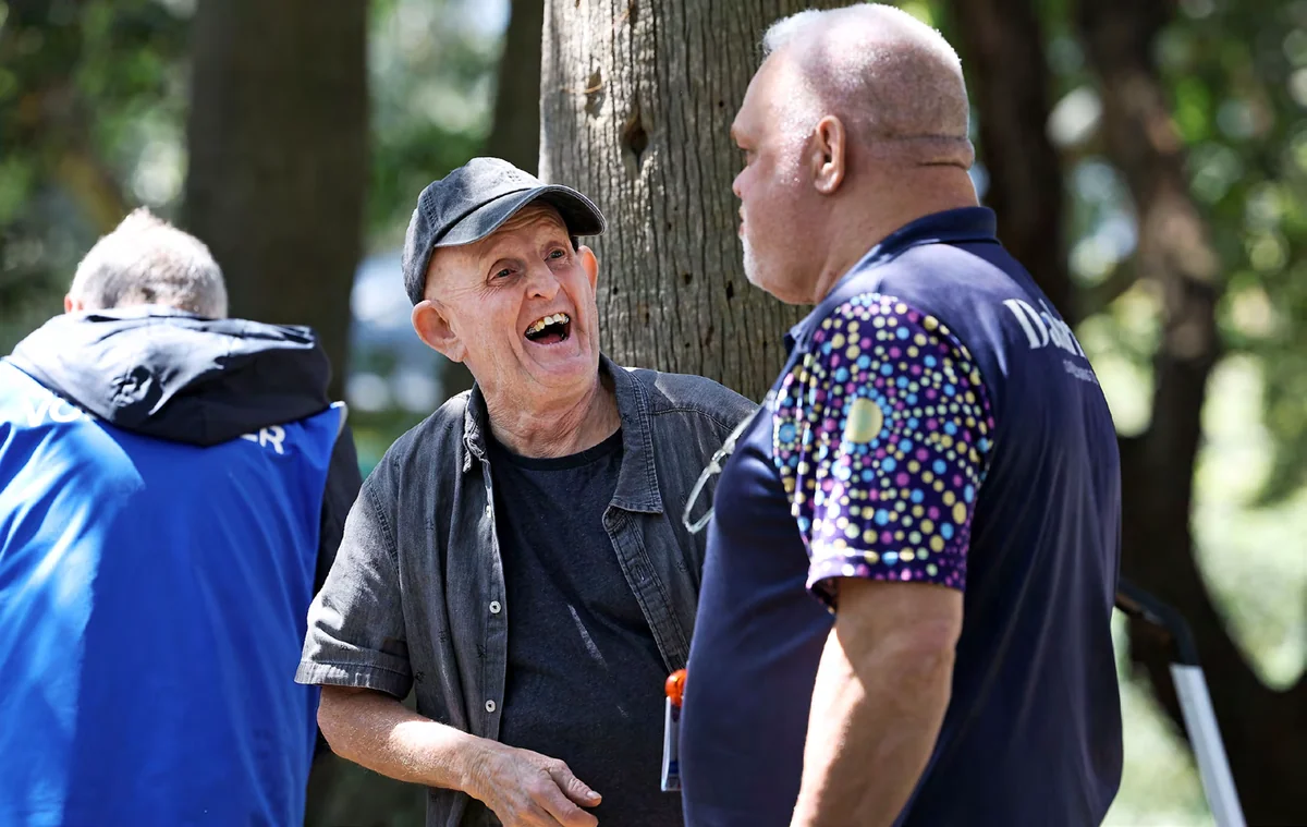 Two men laughing together outdoors at a St Vincent&rsquo;s health outreach service in Darlinghurst