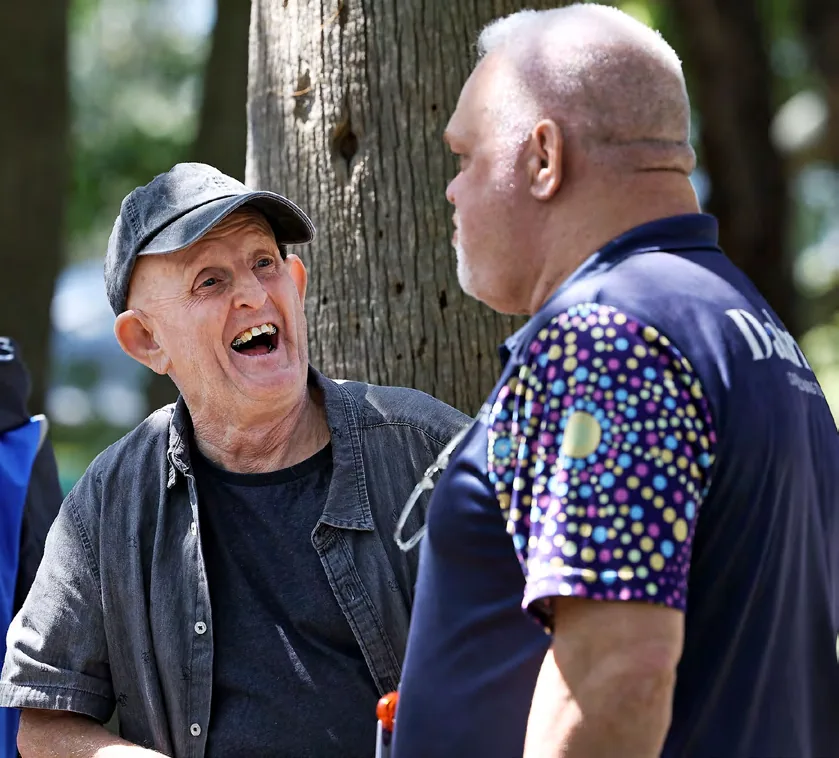 Two men in conversation outdoors at a St Vincent&rsquo;s health outreach service